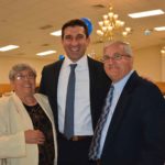 Hampden District Attorney Anthony Gulluni poses with a man and a woman at a campaign event.