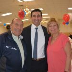 Hampden District Attorney Anthony Gulluni smiles and poses with a man and a woman.