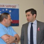 Hampden District Attorney Anthony Gulluni talks to a person at a campaign event.