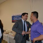Hampden District Attorney Anthony Gulluni shakes hands with a person at a campaign event.