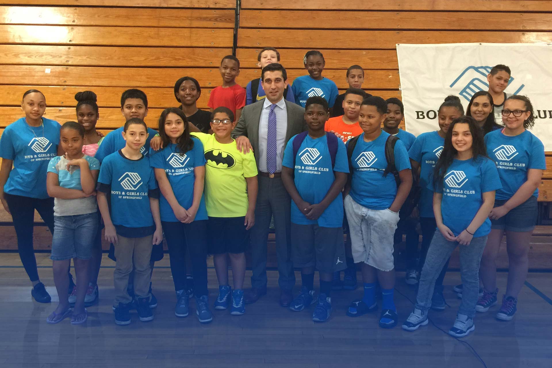 Hampden District Attorney Anthony Gulluni poses for a photo with a group of kids from the boys and girls club.