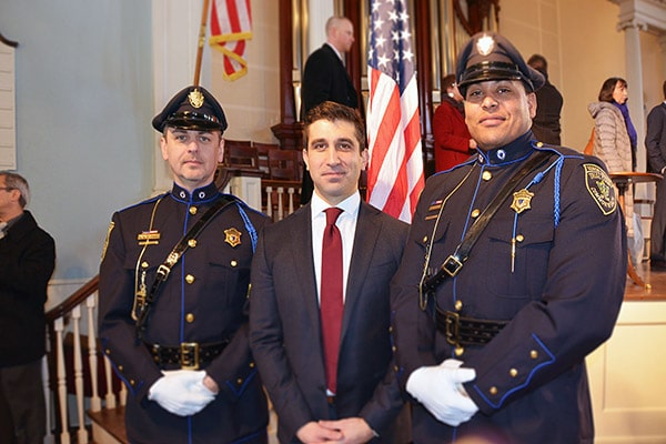 Hampden District Attorney Anthony Gulluni poses for a photo with two police officers.
